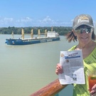 Cindy sipping and reading while passing through Panama Canal.jpg
